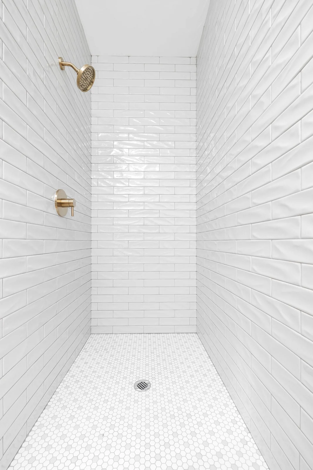 White tiled shower tray and fittings