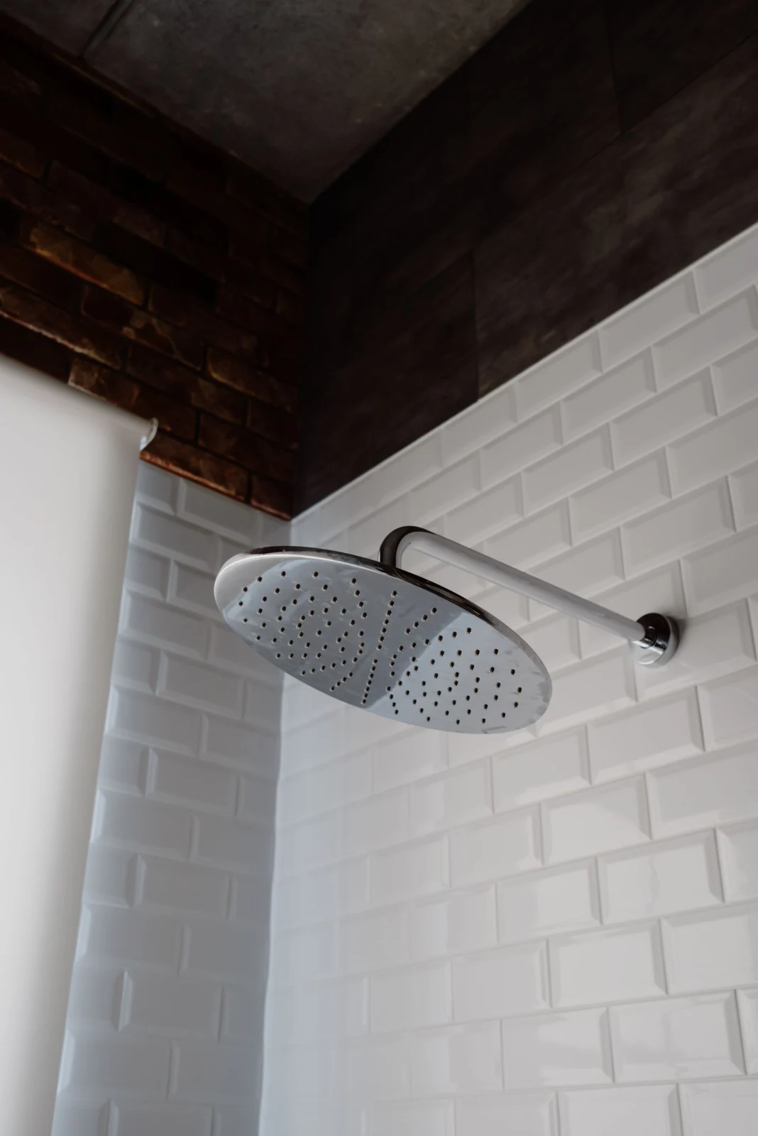 Overhead shower beneath a timber ceiling